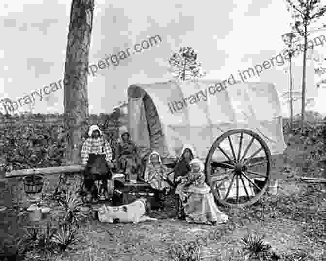 A Group Of African American Pioneers Standing In Front Of A Covered Wagon The Black West: A Documentary And Pictorial History Of The African American Role In The Westward Expansion Of The United States